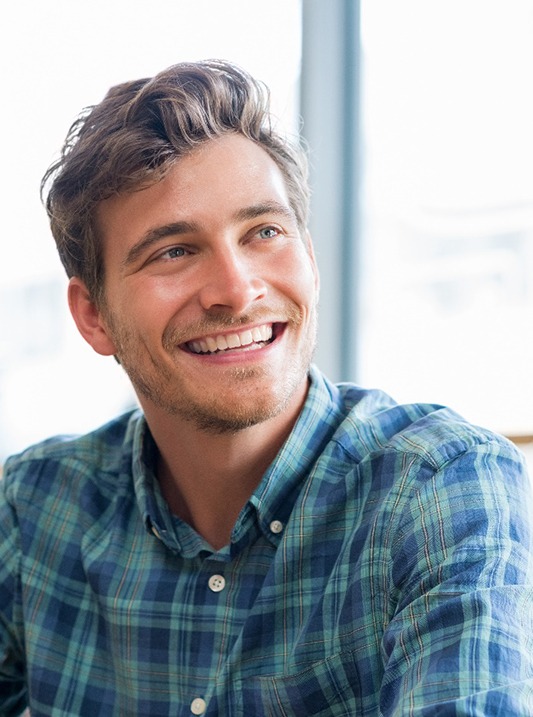 man smiling and talking to woman