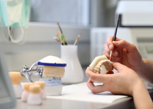 Orthodontic lab technician crafting smile