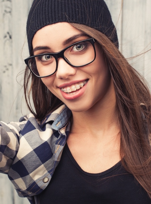 Woman with ceramic braces smiling