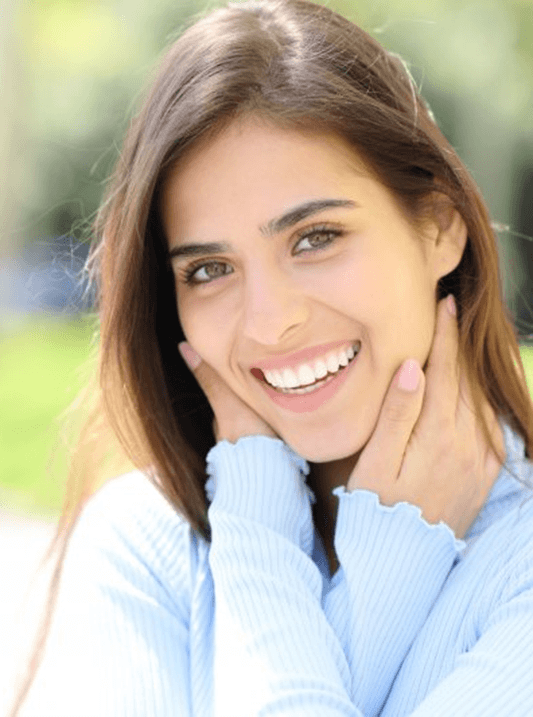 a woman smiling outdoors