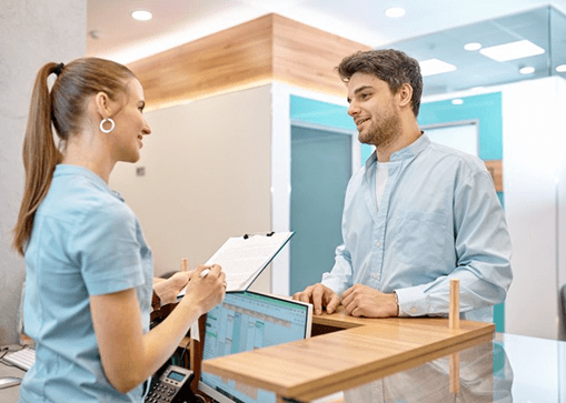 a man speaking with a front desk team member