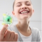 Smiling young person holding a retainer