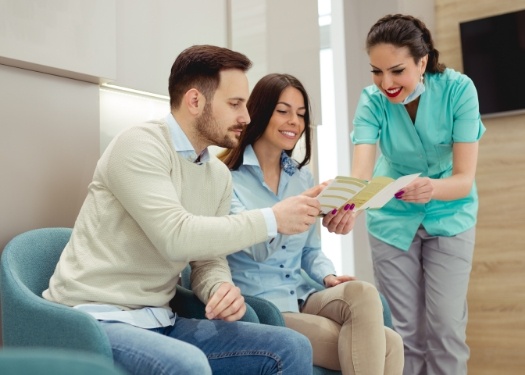 Orthodontic team member showing forms to a patient