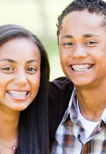Ttwo teens with ceramic braces smiling