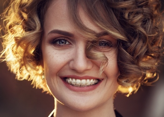 Woman with clear braces smiling
