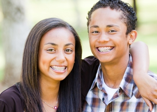Two teens with braces smiling