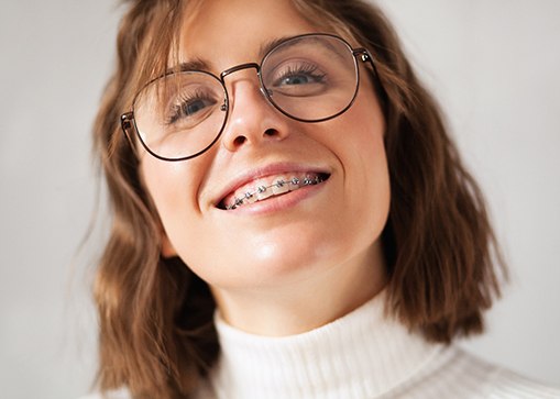 closeup of smiling young woman with braces
