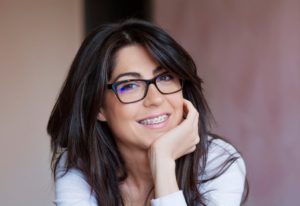 a smiling woman with braces